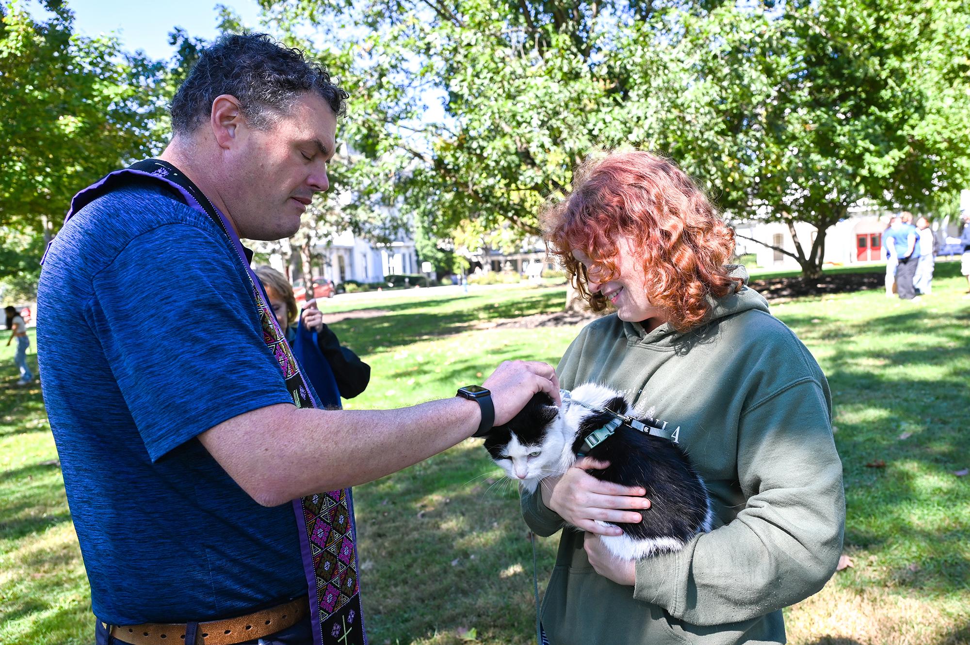 Chaplain blessing a cat