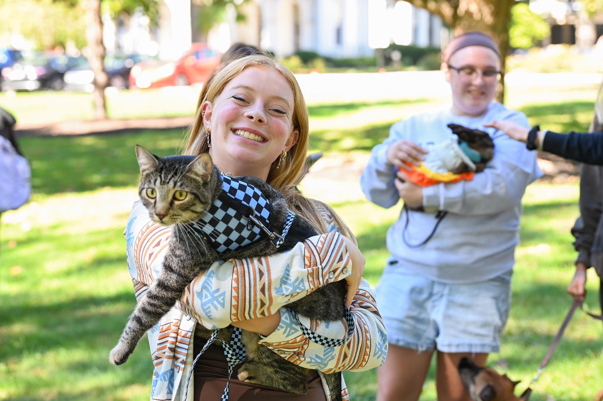 Student holding cat