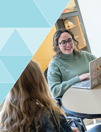 student typing on laptop